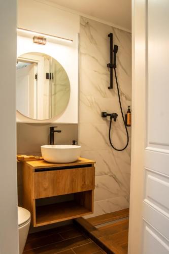a bathroom with a sink and a mirror at Volotel SkyWay in Cluj-Napoca