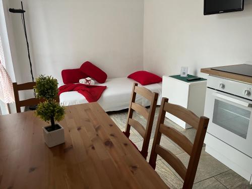 a kitchen with a table and a small room with a bed at Il Casale di David in Pontedera