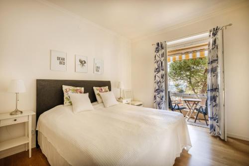 a bedroom with a white bed and a window at 4SONS UMAG Sea View 2BR Apartment in Town center !NEW! in Umag