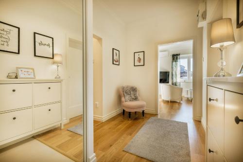 a living room with a mirror and a chair at 4SONS UMAG Sea View 2BR Apartment in Town center !NEW! in Umag