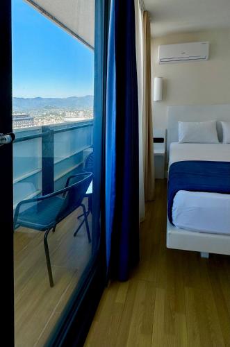 a bedroom with a bed and a window with a view at Orbi City Hotel D1 Block in Batumi
