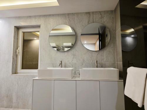 a bathroom with two sinks and a mirror at Blueduck hotel in Seoul