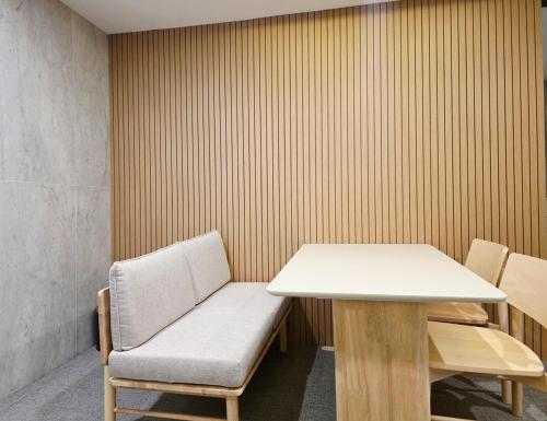a room with a table and a table and a bench at Blueduck hotel in Seoul