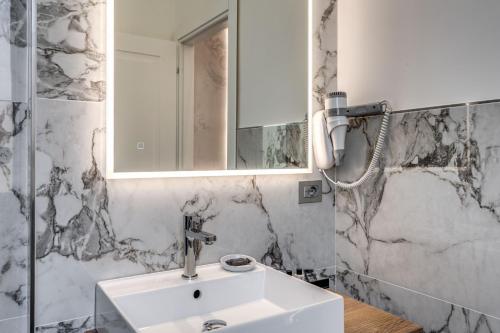 a bathroom with a sink and a mirror at The Spotlight Boutique Hotel in Rome