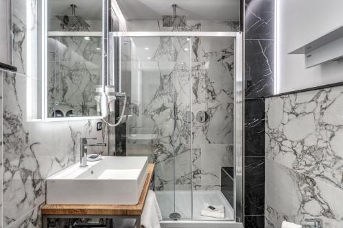 a bathroom with a sink and a shower at The Spotlight Boutique Hotel in Rome