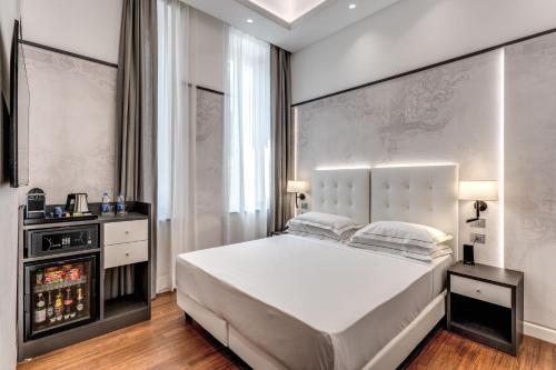 a bedroom with a large white bed in a room at The Spotlight Boutique Hotel in Rome