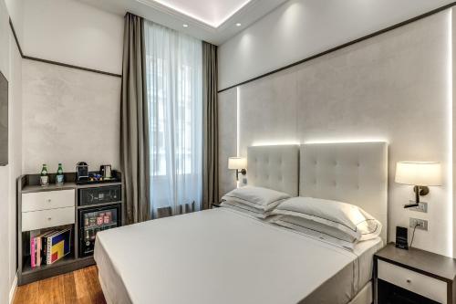 a bedroom with a large white bed and a window at The Spotlight Boutique Hotel in Rome