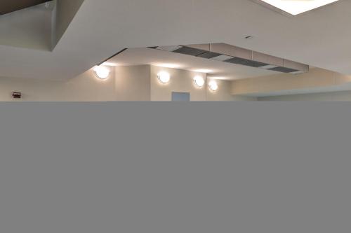 a white room with lights on the ceiling at The Oasis at Orange Beach 2006 (Phoenix West II) in Orange Beach
