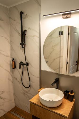 a bathroom with a sink and a shower at Volotel SkyWay in Cluj-Napoca