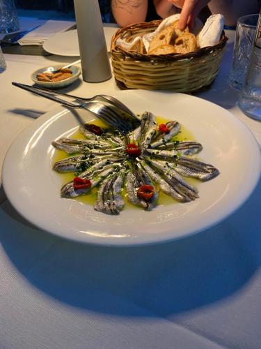 a plate of food with a fork on a table at Villa Orsini - A Retreat in Pisa - Food and Relax in Pisa