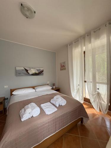 a bedroom with a bed with towels on it at La Casa di Paola in Terni