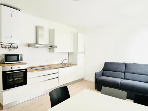 a living room with a couch and a kitchen at Verga - 100 m da Piazza Mazzini - Immobil Relax in Lido di Jesolo
