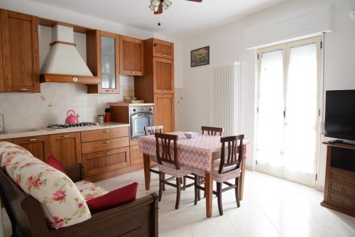 a kitchen with a table and chairs in a room at Casa Relax in Montalbano Ionico