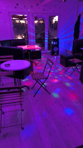 a room with purple and pink lights on the floor at cunami kucica in Belgrade