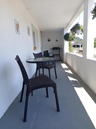 a patio with chairs and a table and a table at Apartman Emma in Visoko