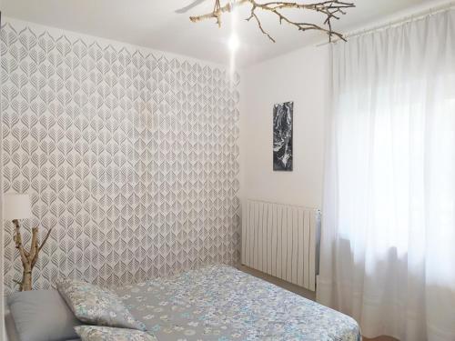 a bedroom with a bed and a wall at Villa dei Fiori in Luino