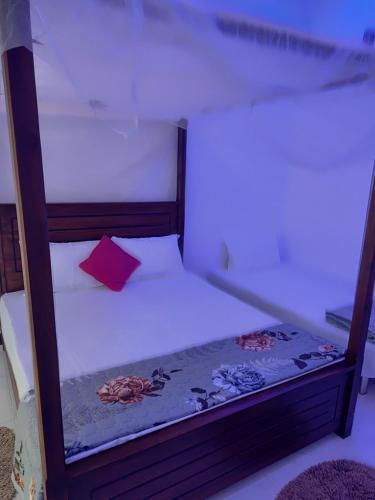 Una cama o camas en una habitación de Ella Thenulya