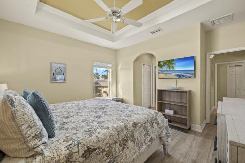 a bedroom with a bed and a ceiling fan at 241 Oasis Pearl- 3BR Pool Home! home in Fort Myers Beach