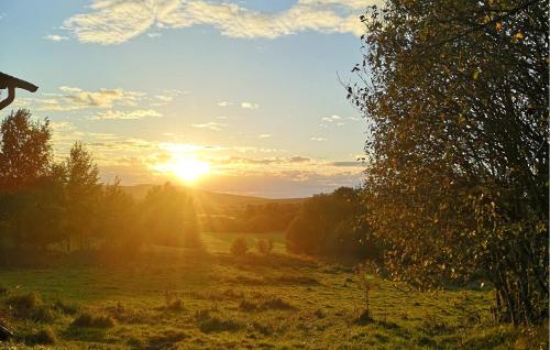 a sunset in a field with the sun in the sky at Lovely Home In Berghem With Wifi in Berghem