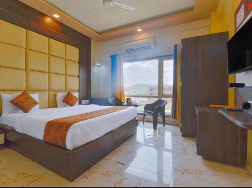a hotel room with a bed and a large window at MANGAL RESIDENCY Mountain View- A Luxury Boutique Business Hotel in Bedla