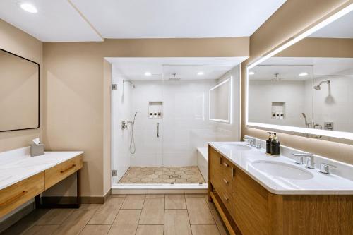a bathroom with two sinks and a shower at Staybridge Suites Oxnard - River Ridge by IHG in Oxnard