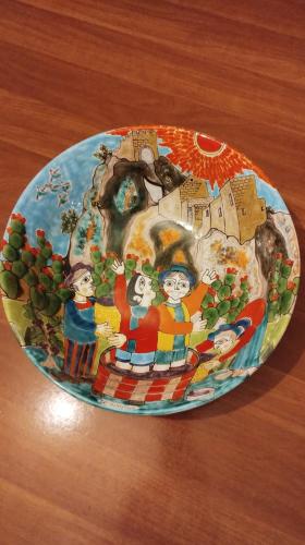 a plate of food on a wooden table at Nino's House in Sperlinga