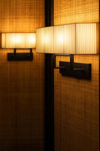 two lights are attached to a wall at SSAW Boutique Hotel Ningbo CBD - Family Friendly & Business Travel in Ningbo