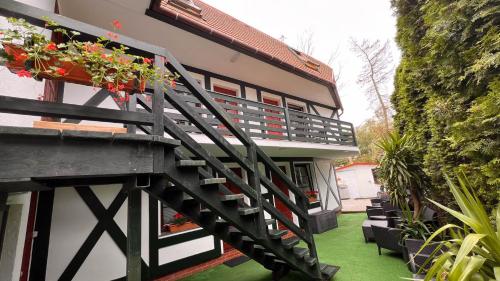 a balcony of a house with flowers on it at Pokoje Wczasowe Barbara in Ustka