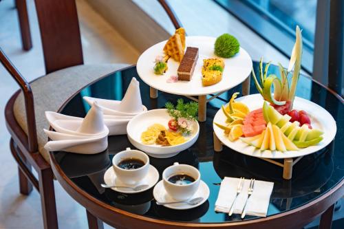 a table with three plates of food on it at SSAW Boutique Hotel Ningbo CBD - Family Friendly & Business Travel in Ningbo