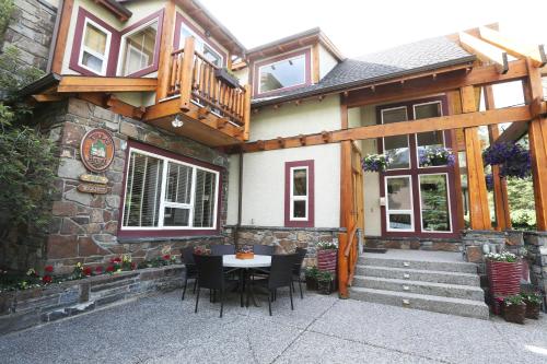 a house with a table and chairs in front of it at Beaujolais Boutique B&B at Thea's House- Adults Only in Banff