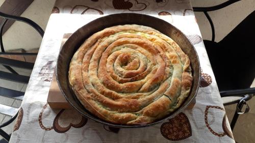 a large pie in a pan on a table at Studio Apartments KIM - Dilberovic in Mostar