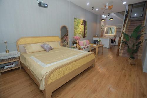 a bedroom with a bed and a living room at Na's Homestay Hải Phòng in Hai Phong