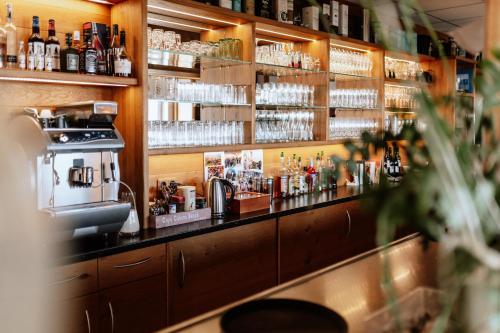a bar with a lot of bottles and alcohol at Die Triniushütte "Thüringens schönste Aussicht" in Rauenstein