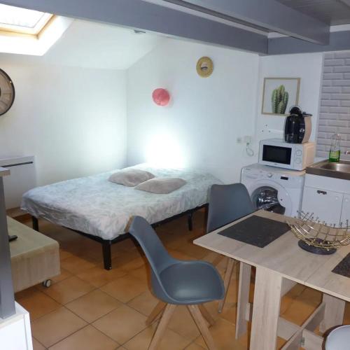 a bedroom with a bed and a table and chairs at Appartement cosy à Amiens avec jardin in Amiens