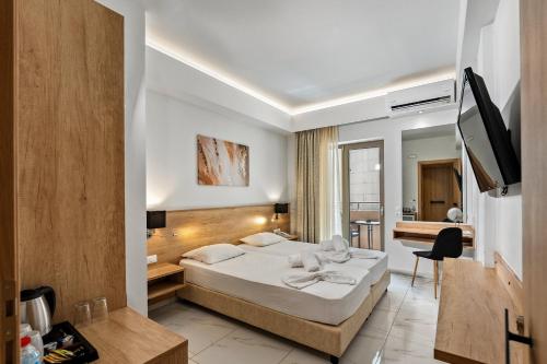 a hotel room with a bed and a bathroom at Marvel Deluxe Rooms in Heraklio Town
