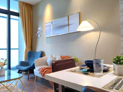 a living room with a couch and a table with a lamp at Riverson SOHO Kota Kinabalu in Kota Kinabalu