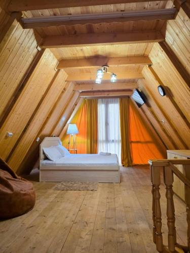 a bedroom with a bed in a attic at Kutaisi Red Water Cottage in Odilauri