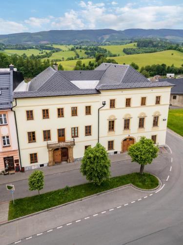a large white building on the side of a road at Hotel Pohoda in Staré Město