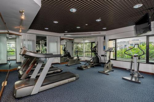 a gym with treadmills and elliptical machines at Grand Diamond Suites Hotel in Bangkok