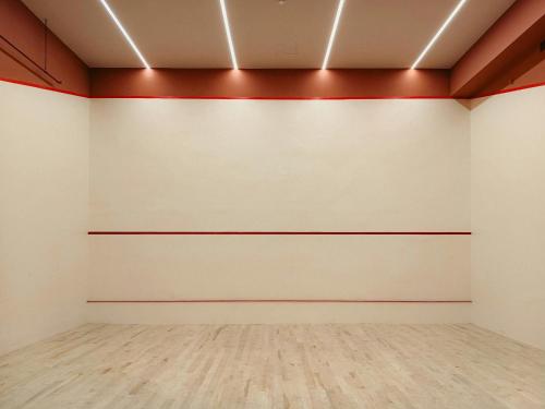 an empty room with white walls and wood floors at Annex at The Stables in the Heart of England in Hinckley
