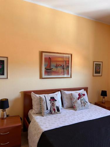 a bedroom with a bed with two dolls on the pillows at Affittacamere Cappuccini in Sassari