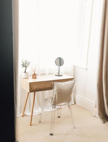a desk with a chair in front of a window at Boho Bay One - Seaside Escape in Cullercoats