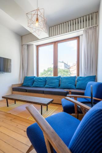 a living room with blue couches and blue chairs at Bright & Central 2BR in Historic Heart of Sofia in Sofia