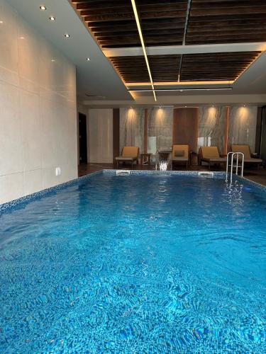 a large blue swimming pool in a hotel room at Boutique Apartment Mostar in Mostar