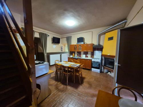 a kitchen and dining room with a table and chairs at Vár-Liget Vendégház in Kisnána