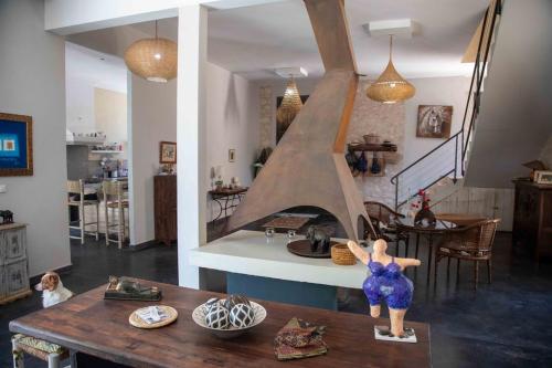 a living room with a table and a staircase at Dar Harmattan in Essaouira