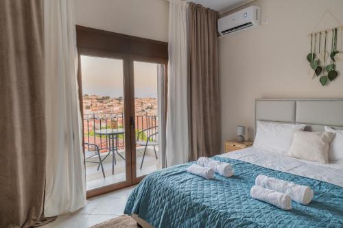 a bedroom with a bed and a balcony with a view at Aegean Nest in Mytilini
