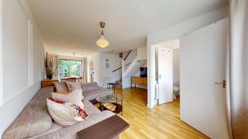 a living room with a couch and a table at 3 Bed House with parking and garden near Tower Bridge in London