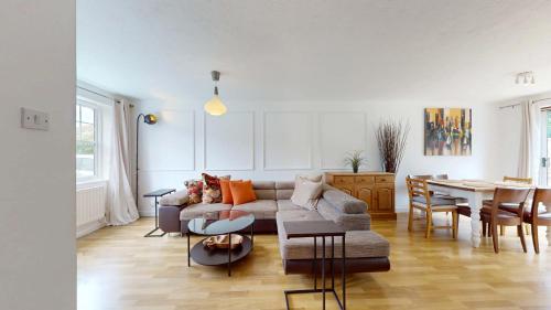 a living room with a couch and a table at 3 Bed House with parking and garden near Tower Bridge in London