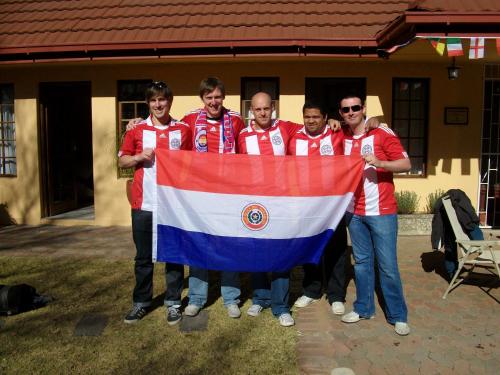 a group of men holding a greek flag at A Cherry Lane Self Catering and B&B in Bloemfontein